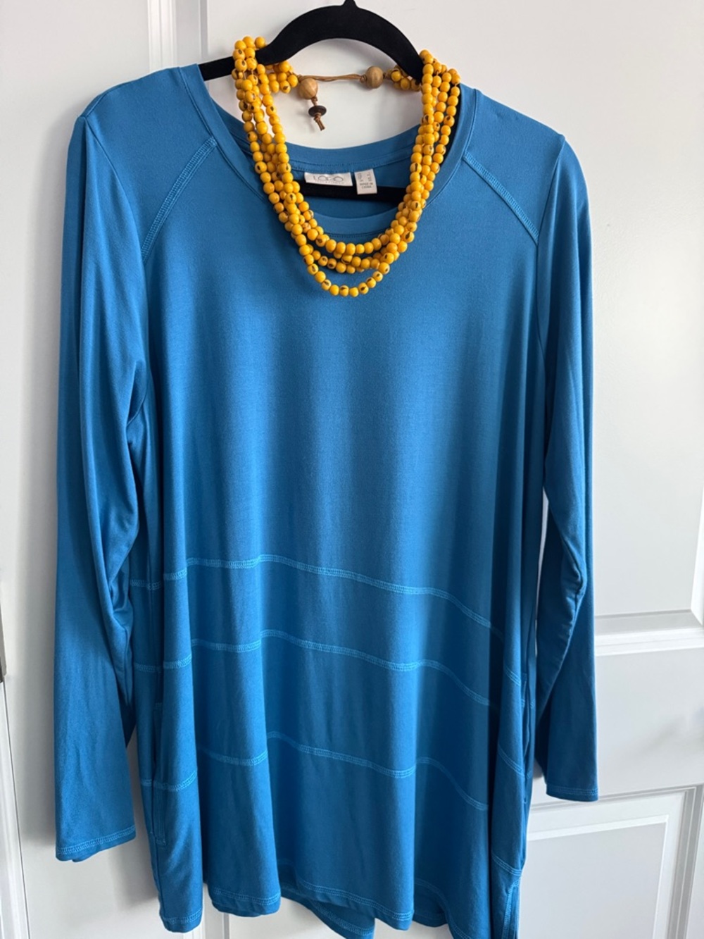 LOGO by Lori Goldstein blue Long Sleeve top with angled hem and pockets.